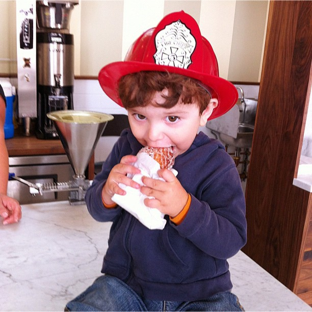 Demo input: a boy in a blue sweatshirt eating donut